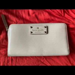 Large cream coloured zippered Kate Spade wallet.